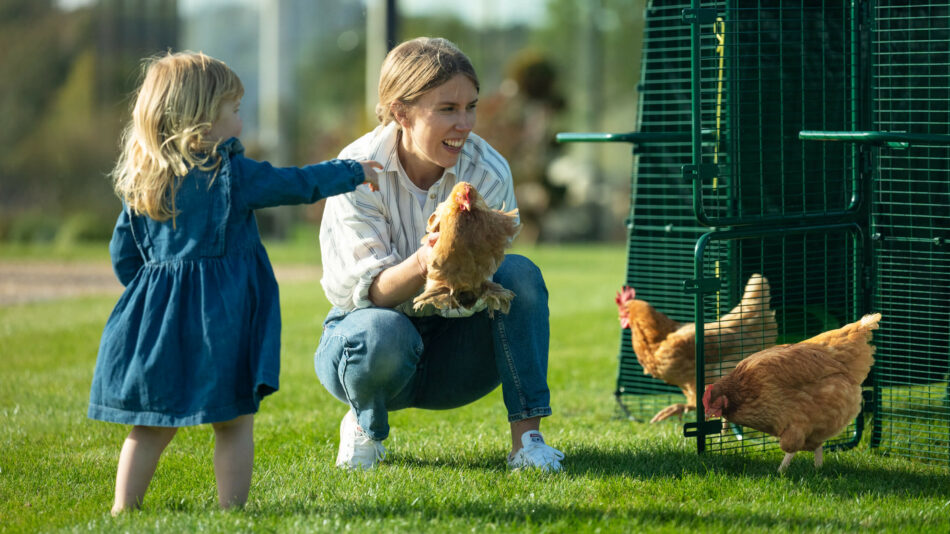 Chicken-behavior-woman-and-girl-with-chickens-outside-the-Eglu-Pro